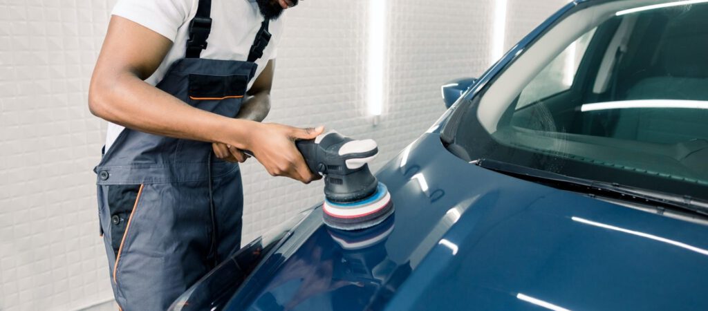 car-detailing-and-polishing-concept-professional-african-male-car-service-worker-holding-in-hands-e1635821197251.jpg